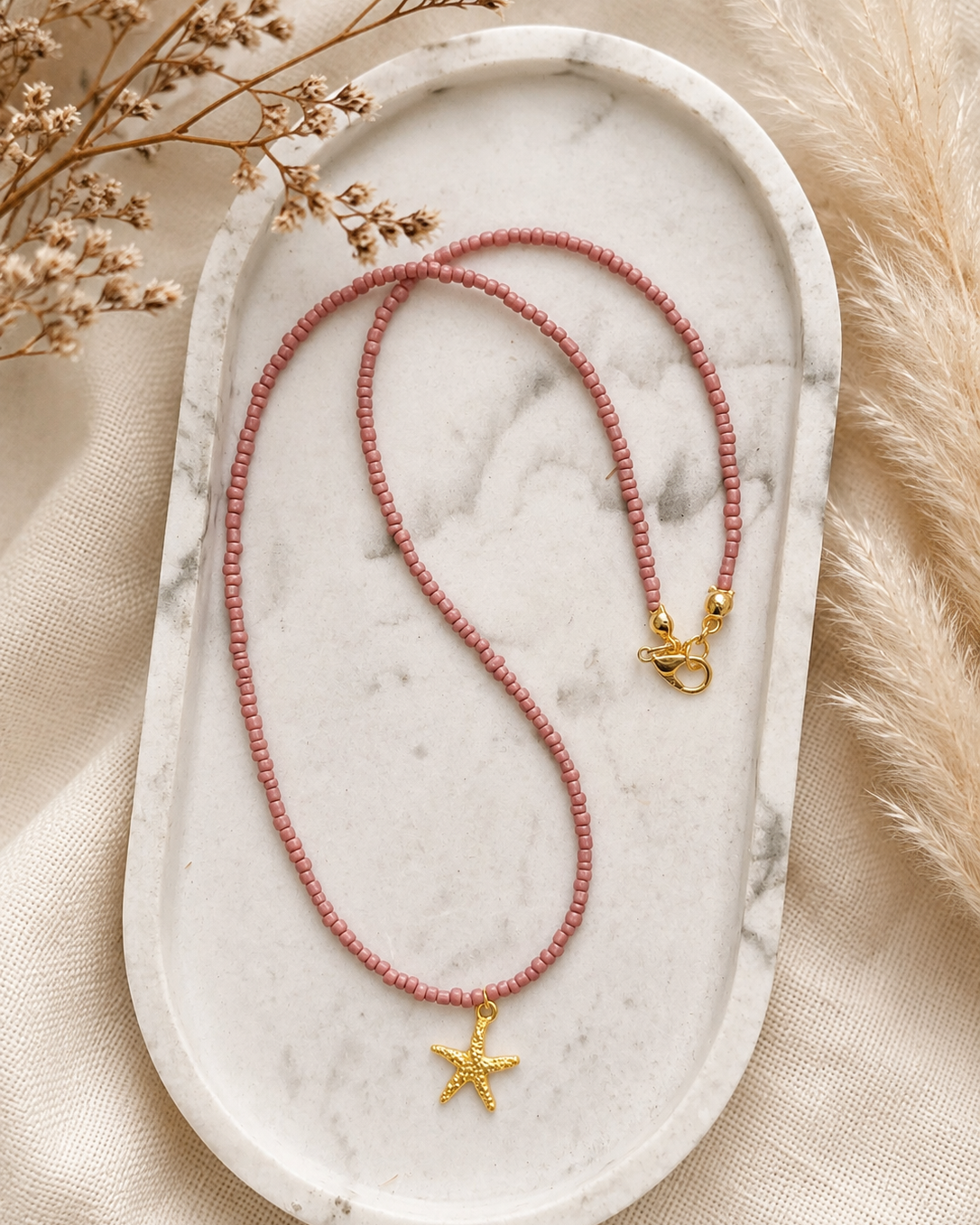 Vintage Rosé oudroze kralenketting met goudkleurige zeester